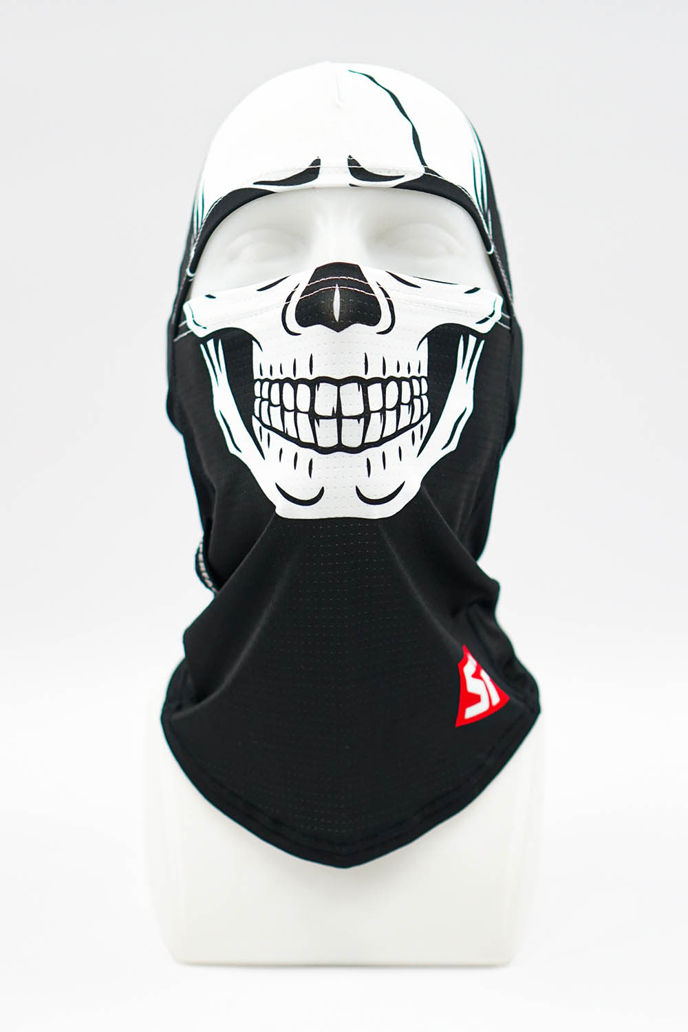 Mannequin head wearing a black balaclava with a white skull graphic covering the lower face.