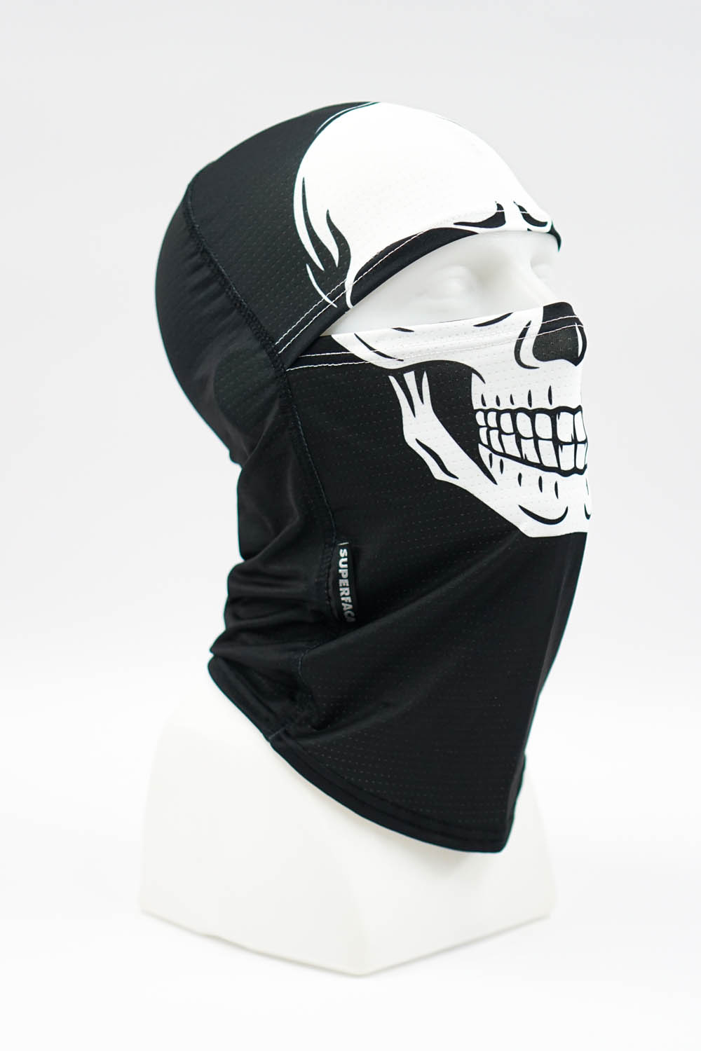 Black balaclava with a white skull graphic worn on a mannequin head
